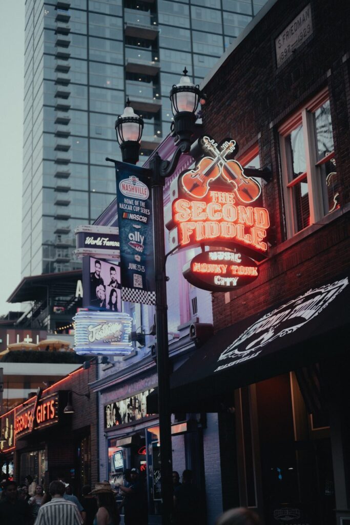 A neon sign on a building in a city