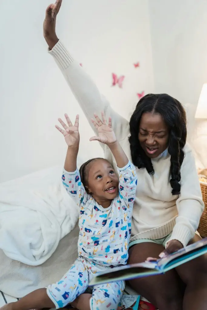 Mother Reading a Book to her Child in the Bedroom