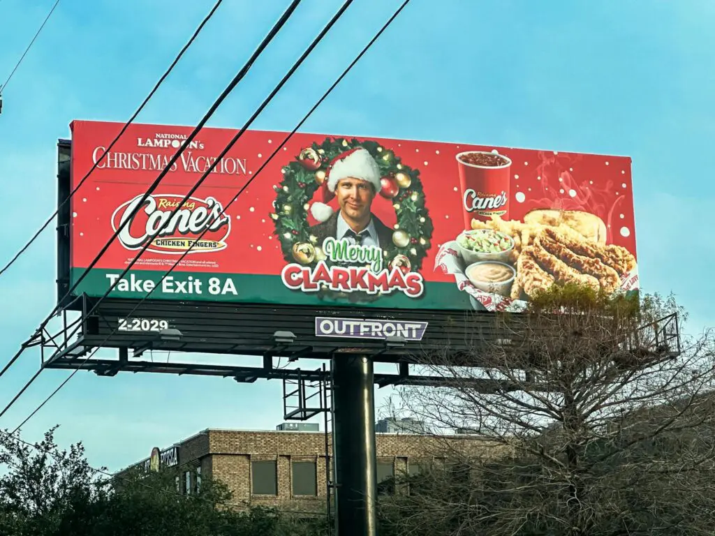 Festive holiday billboard featuring promotional content for a popular chicken restaurant.